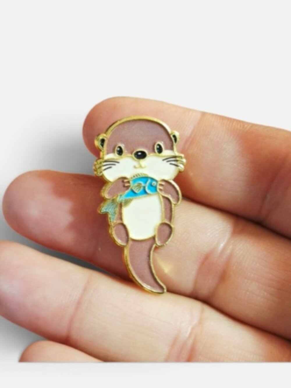 Cute Otter Holding Fish Enamel Pin